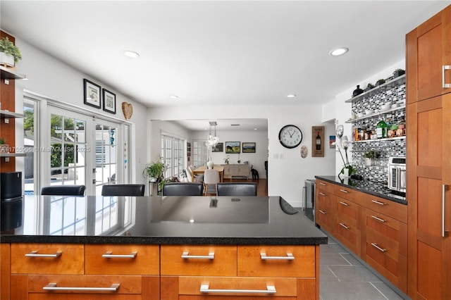 kitchen featuring brown cabinetry, dark tile patterned flooring, french doors, open shelves, and recessed lighting