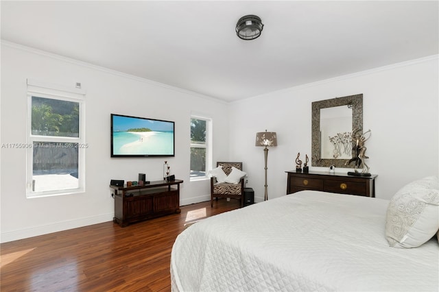 bedroom with dark wood-style floors, ornamental molding, and baseboards