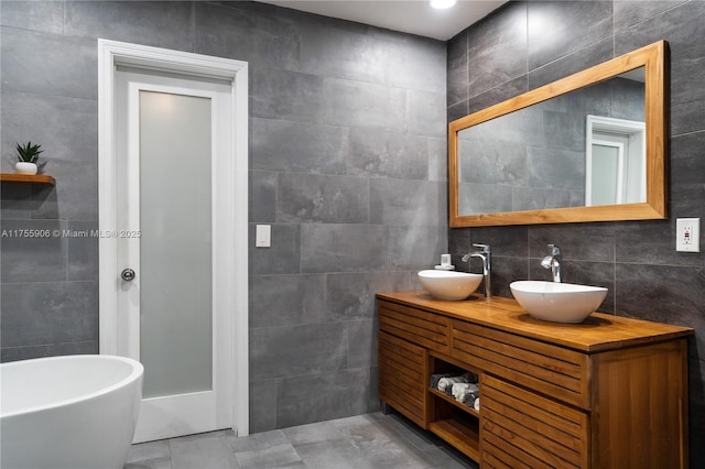 bathroom with double vanity, tile walls, and a sink