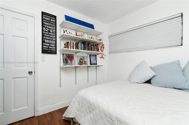 bedroom with dark wood-type flooring