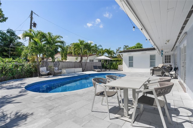 view of swimming pool with a fenced in pool, a patio, a grill, a fenced backyard, and a jacuzzi