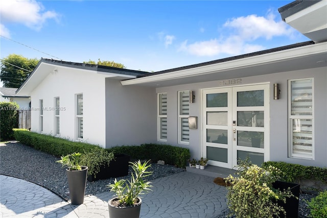 view of exterior entry with stucco siding