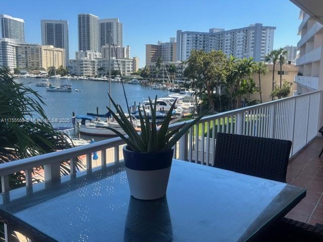 balcony featuring a water view and a view of city