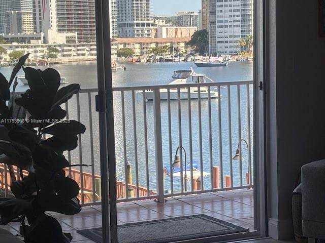 balcony featuring a city view and a water view