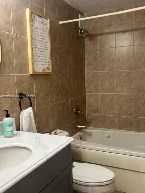 bathroom featuring vanity, shower / bathtub combination, and toilet