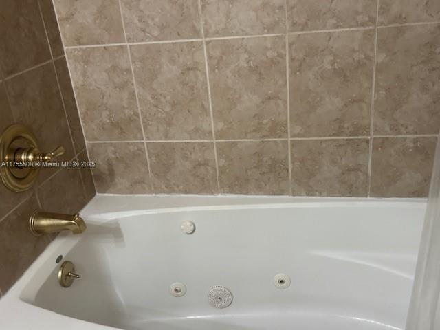 full bath featuring a tub with jets