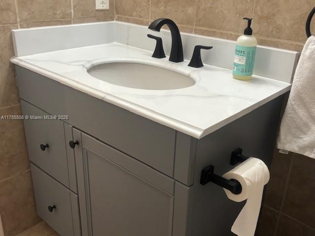 bathroom featuring tile walls and vanity