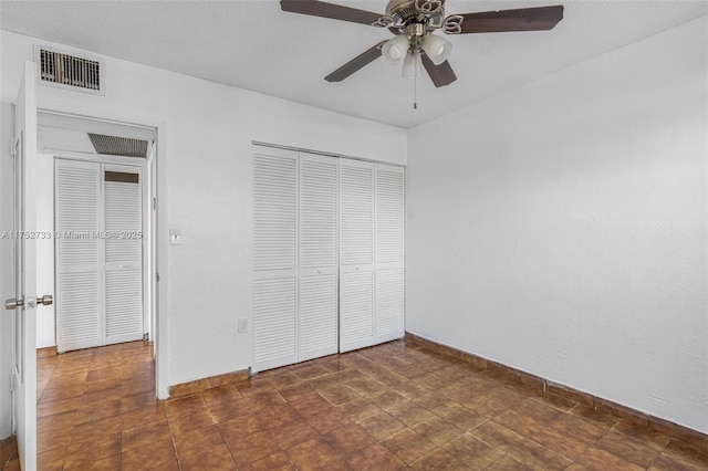 unfurnished bedroom featuring a closet, visible vents, ceiling fan, and baseboards