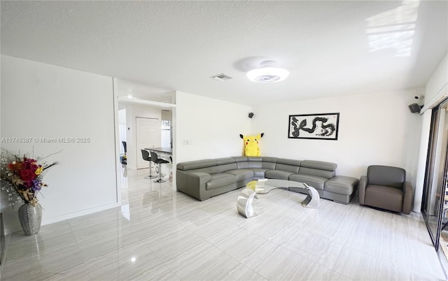9024 NW 45th Ct Unit 9024, Sunrise, FL 33351 - living room with baseboards, visible vents, and a textured ceiling