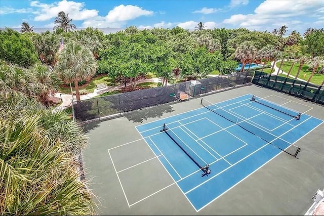 view of tennis court featuring fence