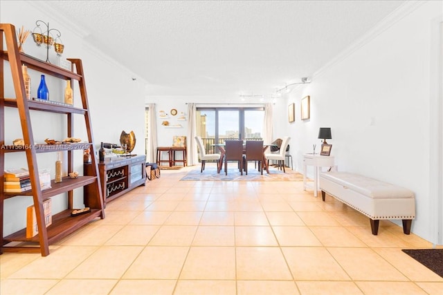 living area featuring light tile patterned floors, a textured ceiling, and crown molding