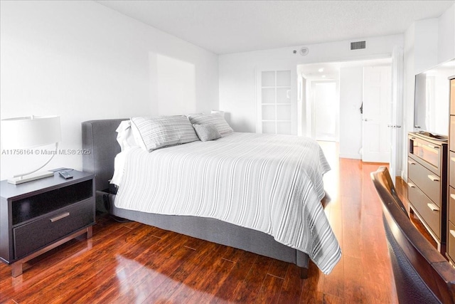 bedroom featuring visible vents and wood-type flooring