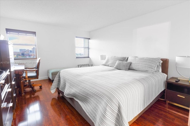 bedroom featuring baseboards and wood-type flooring