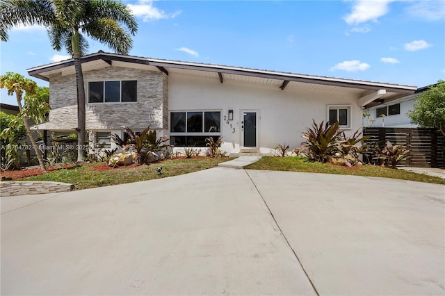 2413 Sugarloaf Ln, Fort Lauderdale, FL 33312 - view of front of home featuring a patio, stone siding, and stucco siding
