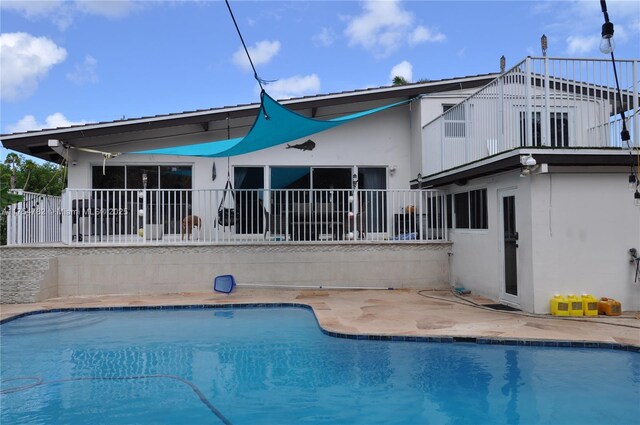 2413 Sugarloaf Ln, Fort Lauderdale, FL 33312 - rear view of house with a patio area, stucco siding, and an outdoor pool