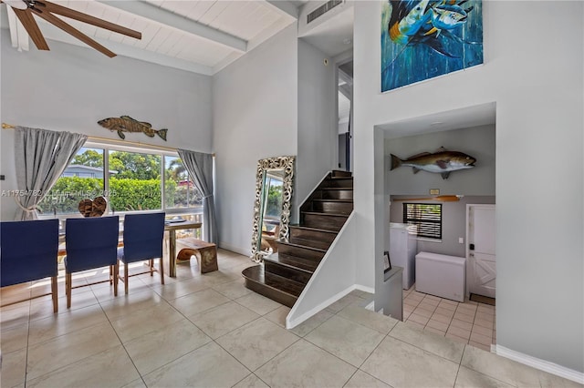 2413 Sugarloaf Ln, Fort Lauderdale, FL 33312 - staircase featuring high vaulted ceiling, baseboards, tile patterned floors, and beam ceiling