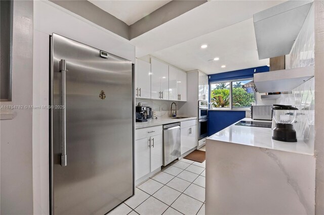 2413 Sugarloaf Ln, Fort Lauderdale, FL 33312 - kitchen with light tile patterned flooring, modern cabinets, white cabinets, a sink, and stainless steel appliances