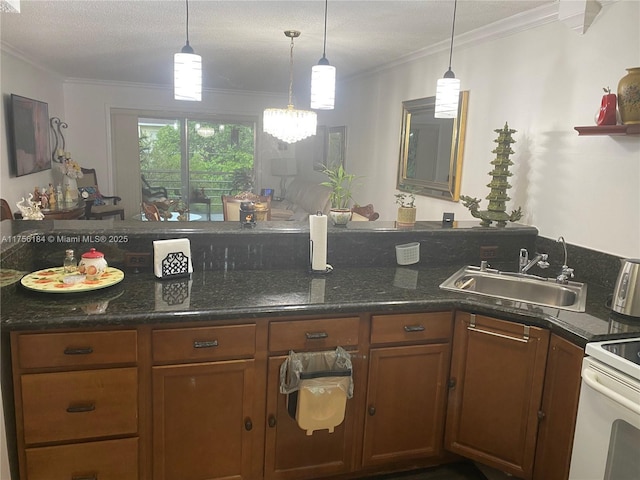 kitchen with hanging light fixtures, ornamental molding, brown cabinetry, and a sink