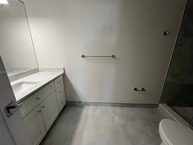 bathroom with vanity, toilet, and walk in shower