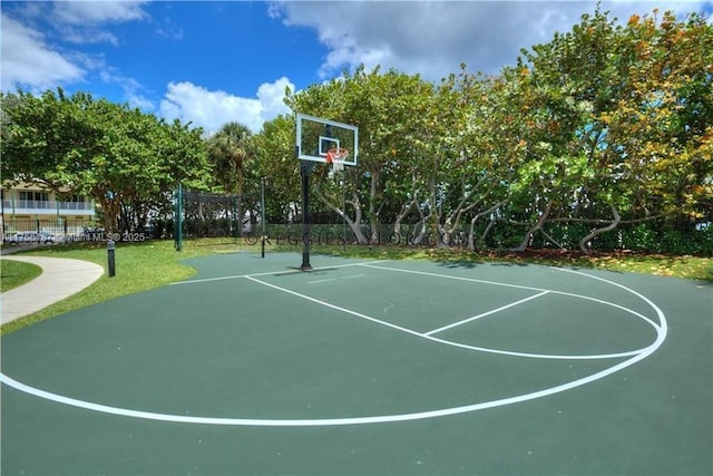 view of basketball court featuring community basketball court and fence