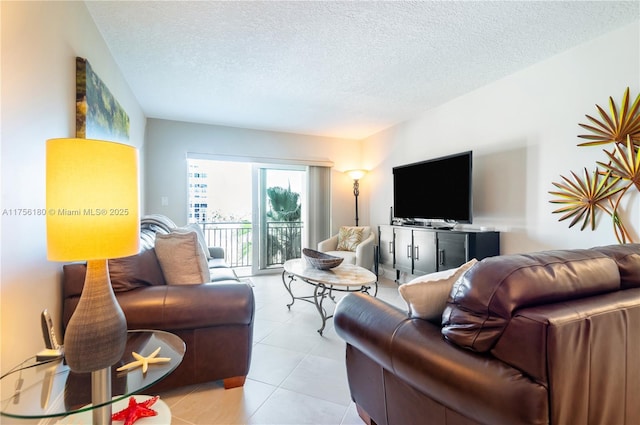 living room featuring light tile patterned floors and a textured ceiling