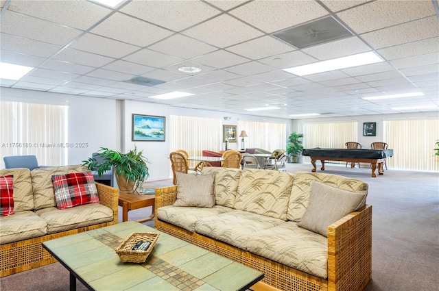 living room featuring a paneled ceiling and carpet flooring