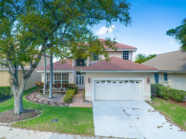 view of front of house with a tile roof, driveway, an attached garage, and stucco siding