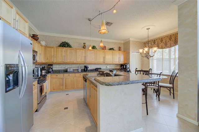 7800 NW 29th St, Margate, FL 33063 - kitchen with a breakfast bar area, an inviting chandelier, visible vents, light brown cabinets, and appliances with stainless steel finishes