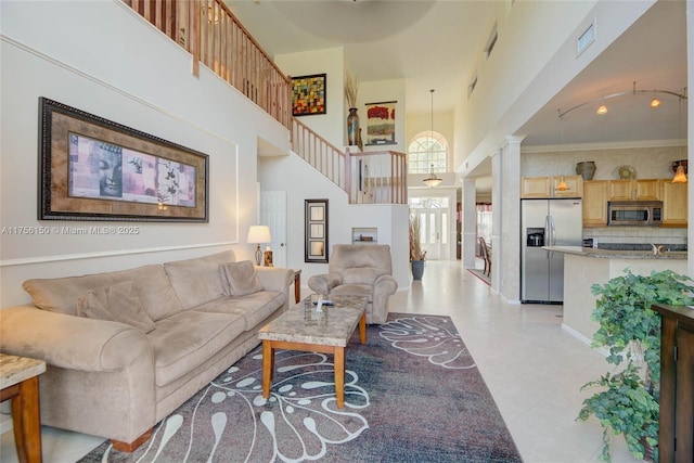 7800 NW 29th St, Margate, FL 33063 - living room with a high ceiling, rail lighting, stairway, and visible vents
