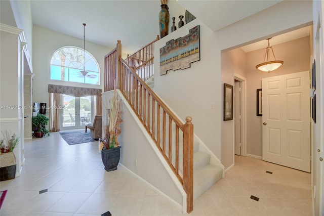 7800 NW 29th St, Margate, FL 33063 - entrance foyer featuring baseboards, stairs, a towering ceiling, and light tile patterned flooring