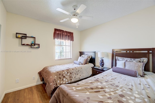 7800 NW 29th St, Margate, FL 33063 - bedroom with baseboards, wood finished floors, ceiling fan, and a textured ceiling