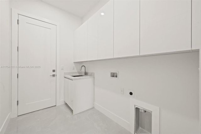 laundry area featuring hookup for a washing machine, a sink, baseboards, cabinet space, and electric dryer hookup