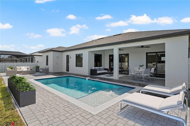 exterior space with a patio, outdoor lounge area, and stucco siding