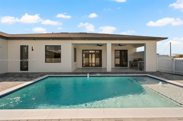 view of swimming pool with a fenced in pool, a patio area, fence, and ceiling fan