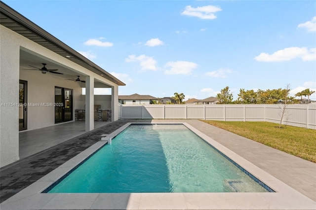 view of pool with a fenced in pool, a yard, a patio, ceiling fan, and a fenced backyard