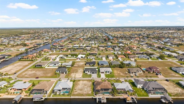 birds eye view of property featuring a residential view and a water view