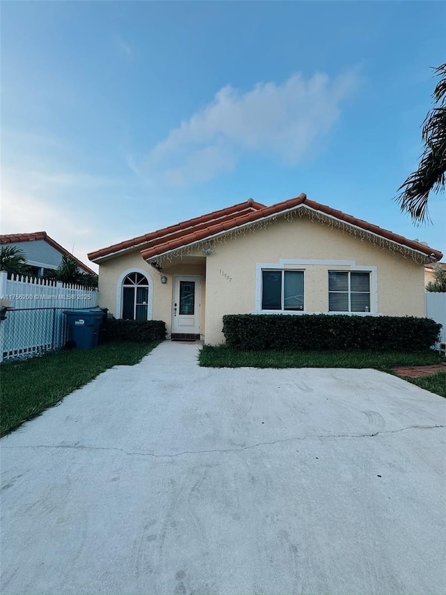 ranch-style house with fence and stucco siding