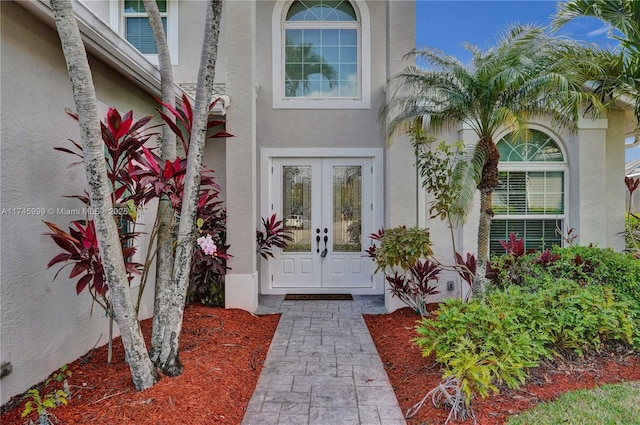 property entrance with french doors and stucco siding