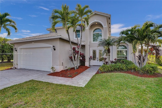 mediterranean / spanish-style house with an attached garage, concrete driveway, french doors, stucco siding, and a front lawn