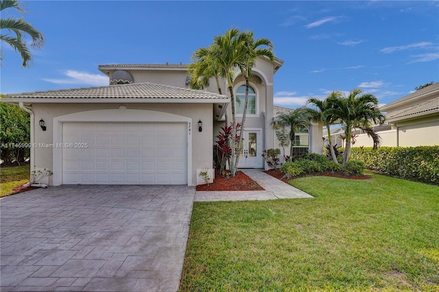 view of front facade with an attached garage, a tiled roof, decorative driveway, stucco siding, and a front lawn
