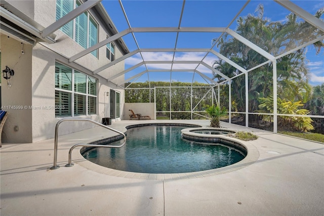 outdoor pool featuring an in ground hot tub, a patio area, and glass enclosure