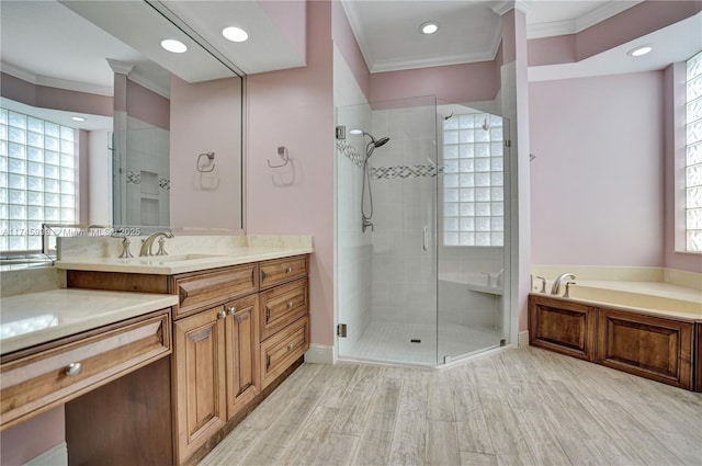full bathroom with a bath, a stall shower, crown molding, and vanity