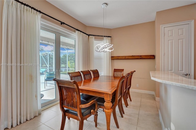 dining room with light tile patterned floors and baseboards