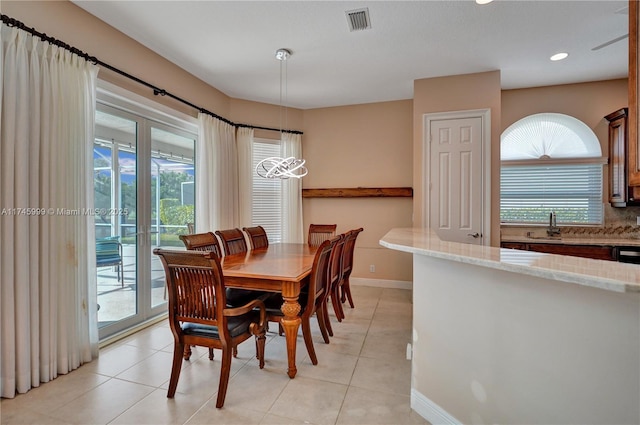 dining space featuring light tile patterned floors, a wealth of natural light, visible vents, and baseboards