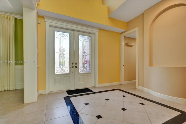 foyer entrance with french doors, tile patterned flooring, and baseboards