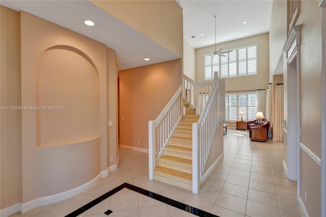 stairway with recessed lighting, tile patterned floors, and baseboards