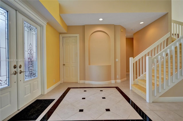 entryway with french doors, recessed lighting, tile patterned flooring, baseboards, and stairs