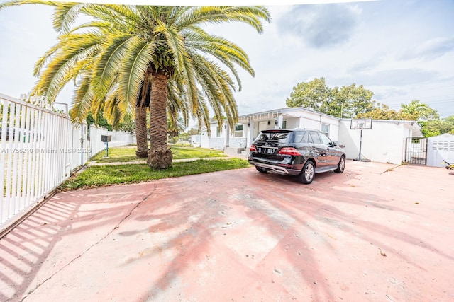 exterior space featuring driveway and fence