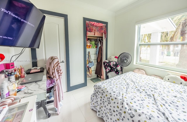 bedroom featuring a closet, multiple windows, crown molding, and light tile patterned flooring