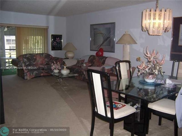 carpeted dining room featuring a chandelier